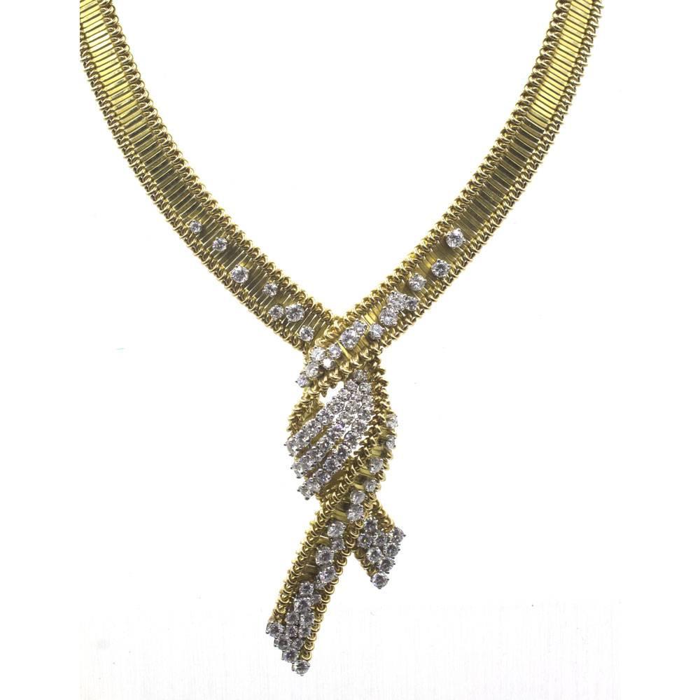 This magnificent French diamond necklace is circa 1960's. The flexible ribbed 18 karat yellow gold necklace is beautifully crafted with round brilliant cut diamonds. There are 70 diamonds that equal approximately 6.85 carat total weight. The
