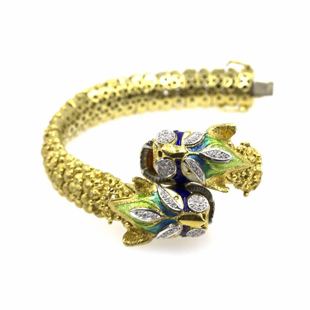 This fabulous bracelet is crafted primarily of textured 18K yellow gold and is accented with white gold and brightly colored enamels. Additionally, there are .50 carat total weight of diamonds added for an overall sparkle. The bracelet measures 7