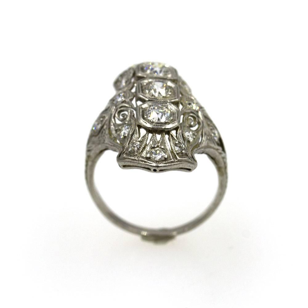 This fabulous Art Deco Diamond Ring is Crafted in Platinum. The elongated ring features three main diamonds in the center as well as diamonds in the platinum mounting. The top of the ring measures 1 inche in length and .75 inches in width. Currently