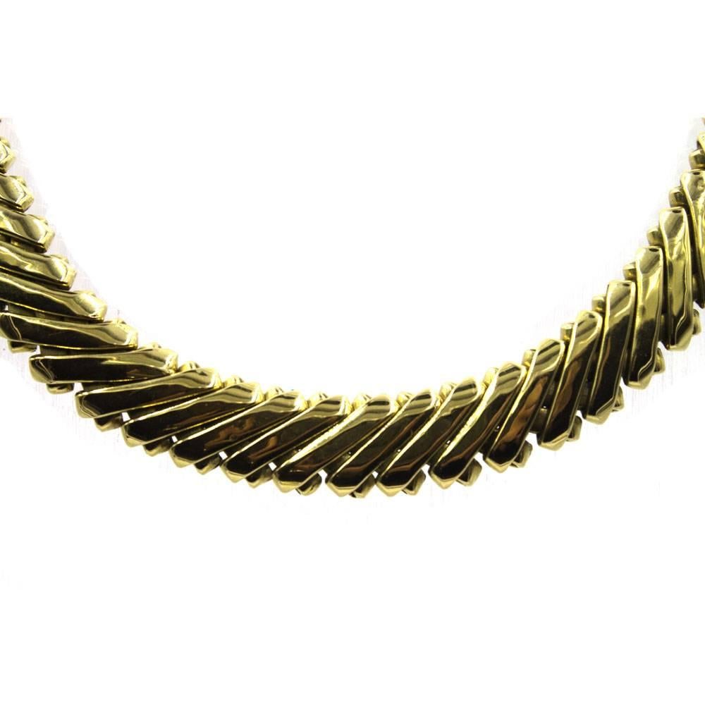 This luxurious collar necklace is crafted in solid 18 karat yellow gold. The linear gold links are flexible and measure 16.5 inches in length. 