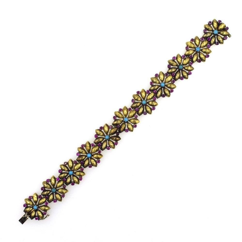 This beautiful Italian Floral Link Vintage Bracelet is crafted in 18 karat yellow gold. Each etched floral link features colorful turquoise and ruby gemstones. The bracelet measures 7.25 inches in length, and is stamped Italy 18K. 