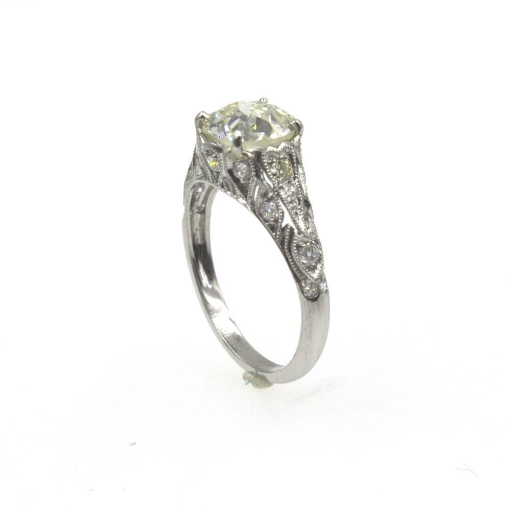 Beautiful and timeless, this  engagement ring features a 2.02 Old European Cut Diamond. The diamond has a warm color graded L-M and SI2 clarity. The diamond perfectly fits in this beautifully crafted platinum filigree mounting with an additional .39