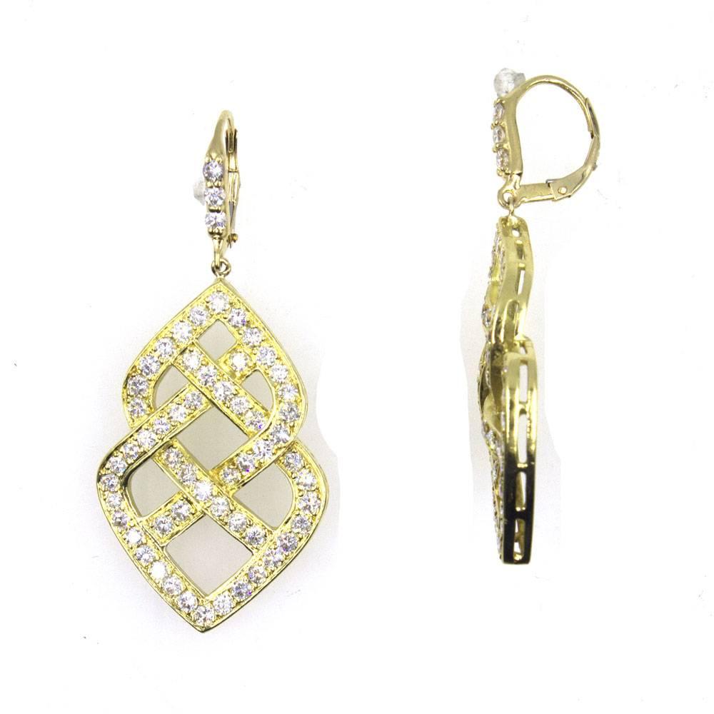 These elegant figure of eight diamond drop earrings are fashioned in 18 karat yellow gold. The 116 round brilliant cut diamonds are graded G-H color and VS2-SI1 clarity. The stylish drops measure 2.0 inches in length and 1.0 inch in width. 