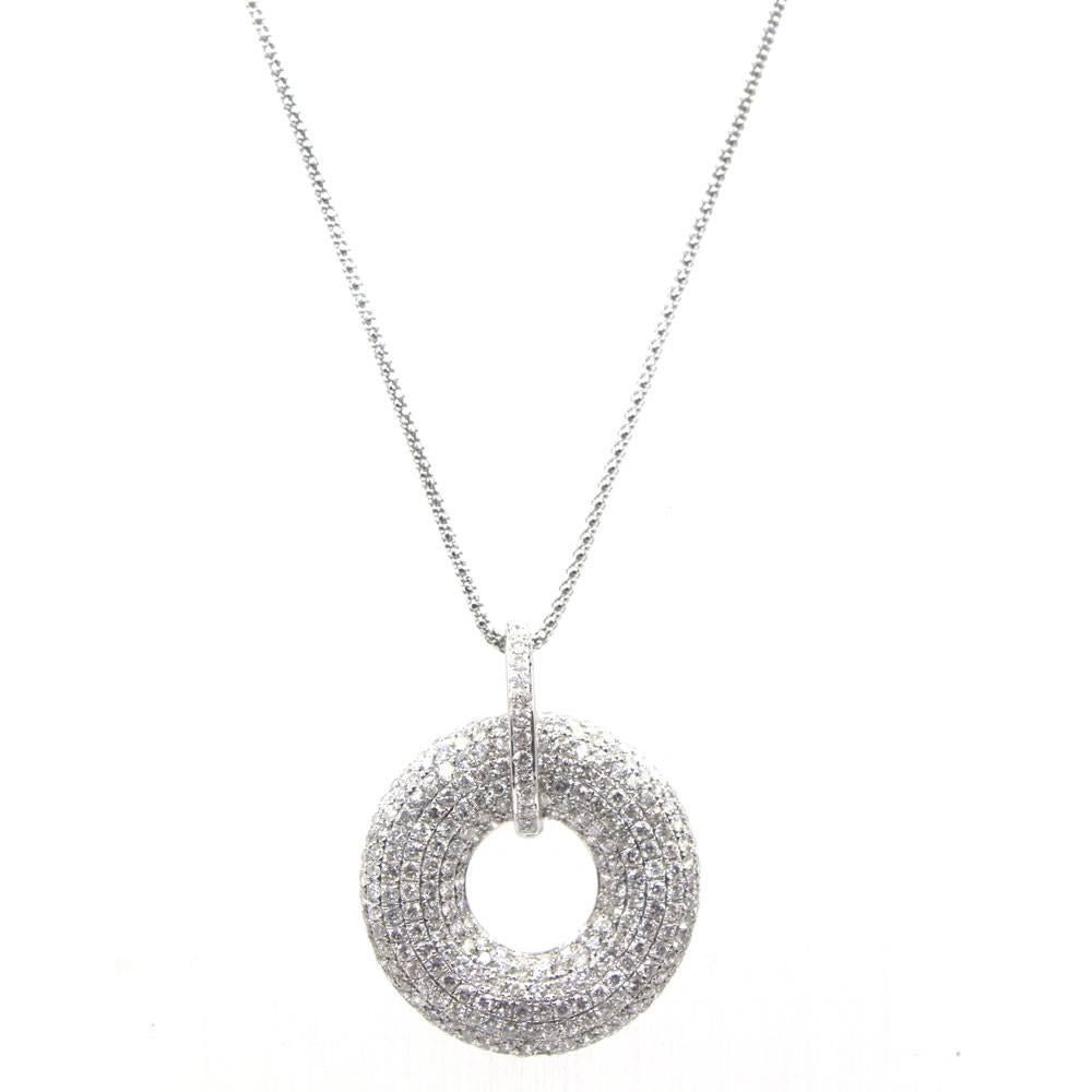 Round brilliant diamonds sparkle in this gorgeous drop pendant. Fashioned in 18 karat white gold, the estate pendant features 4.13 carats of diamonds graded G-H color and SI1-2 clarity. The pendant measures 1.2 inches in diameter and the chain 16