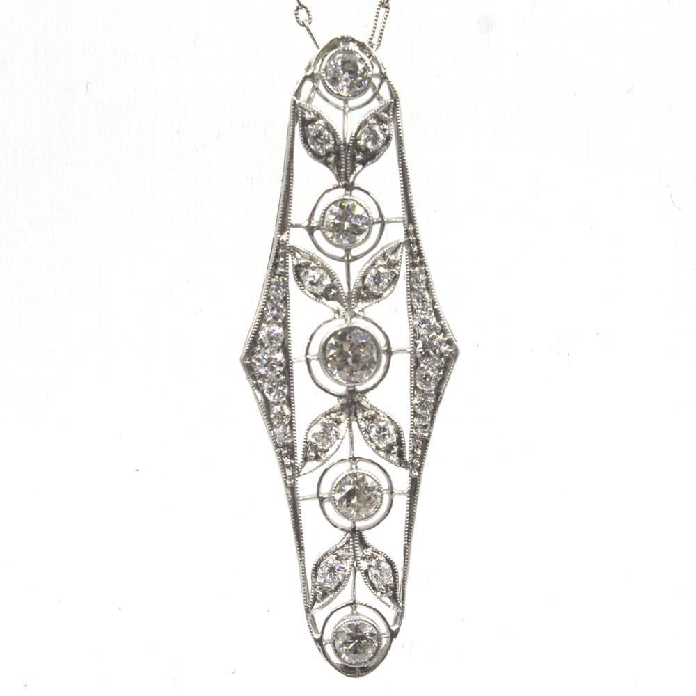 Stunning original Art Deco Diamond Pendant. This timeless necklace is beautifully crafted in platinum and features 1.75 carat total weight of Old European Cut Diamonds. The pendant measures 2 inches in length, .75 inches in width, and comes on an