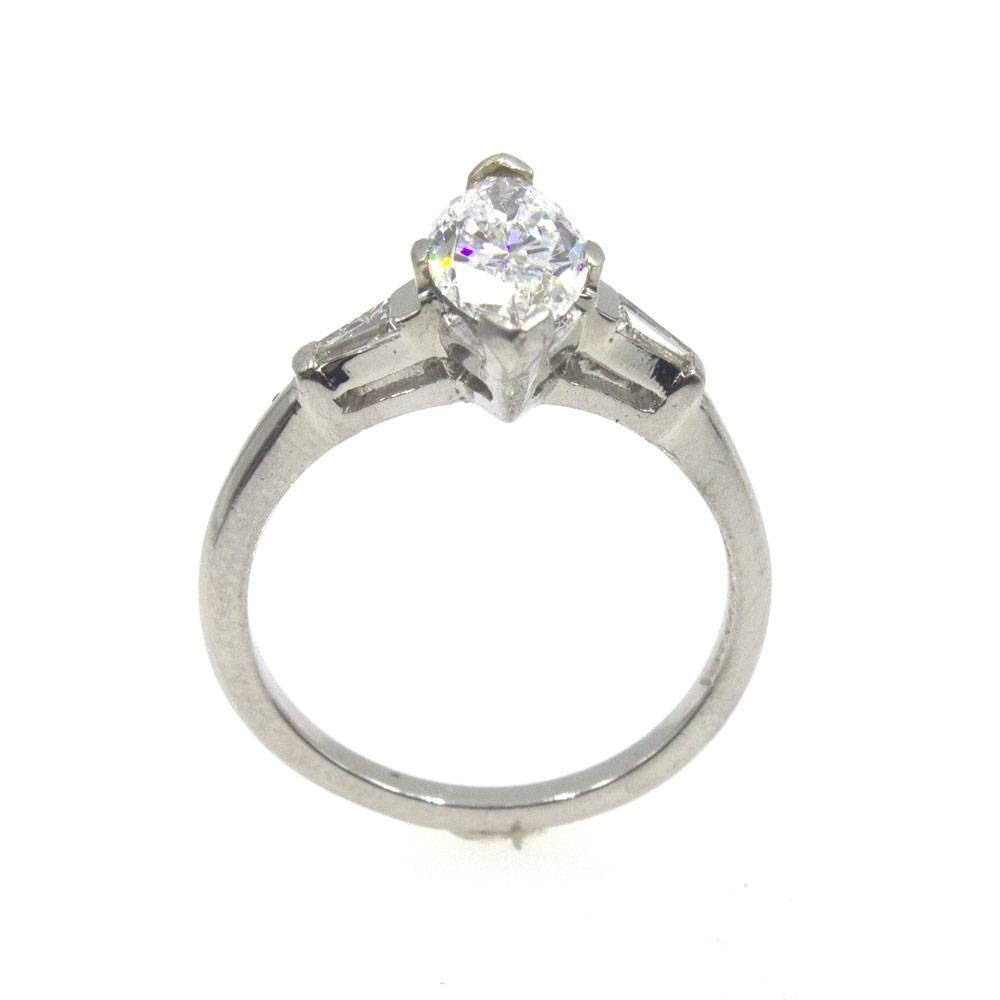 Stunning marquise diamond engagment ring. The 1.18 carat marquise diamond is graded F color and SI2 clarity by the GIA. The diamond is mounted in platinum with two tapered baguettes on either side equaling approximately .14 carat total weight. 
GIA