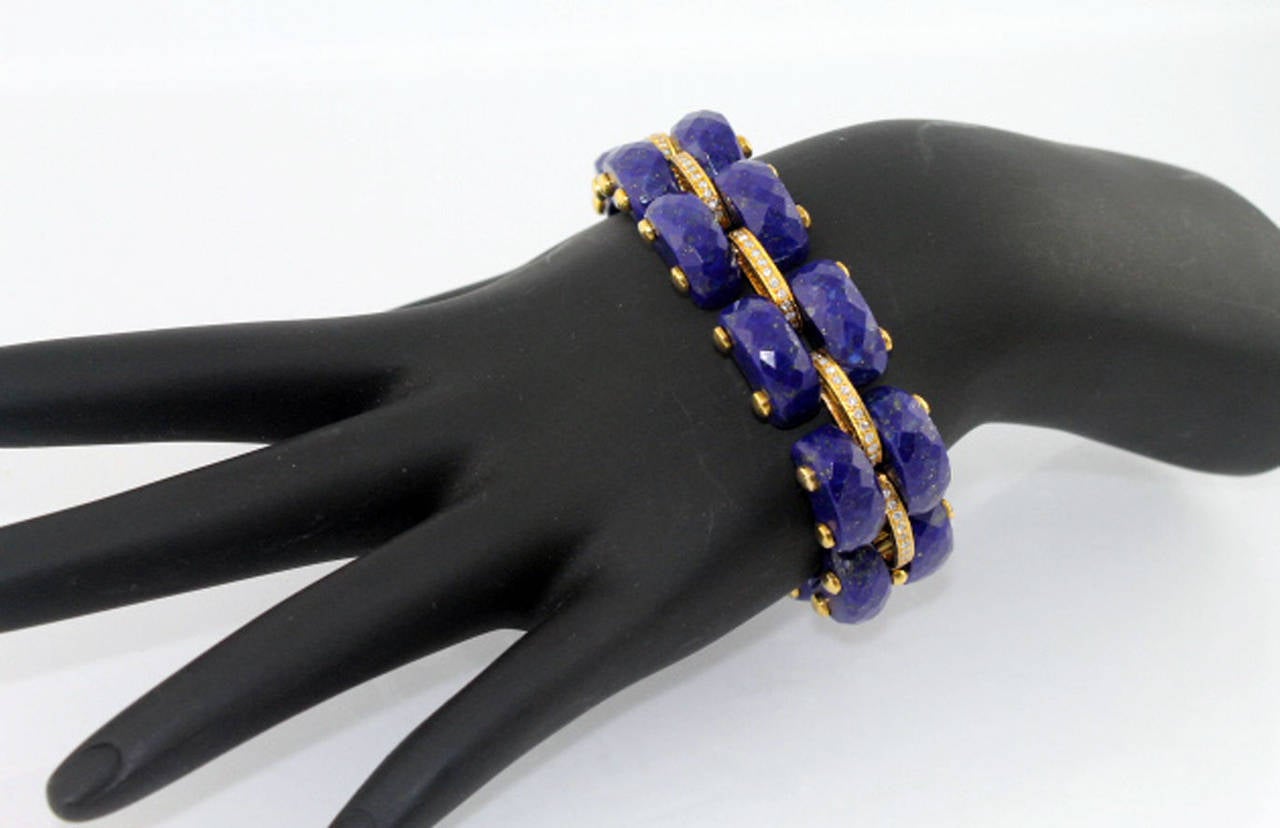 Incredibly made 14 karat yellow gold, diamond, and carved lapis link bracelet. There are 10 stations of diamonds with 140 diamonds weighing approximately 1 carat total weight. The lapis is faceted, and reflects light beautifully. The bracelet
