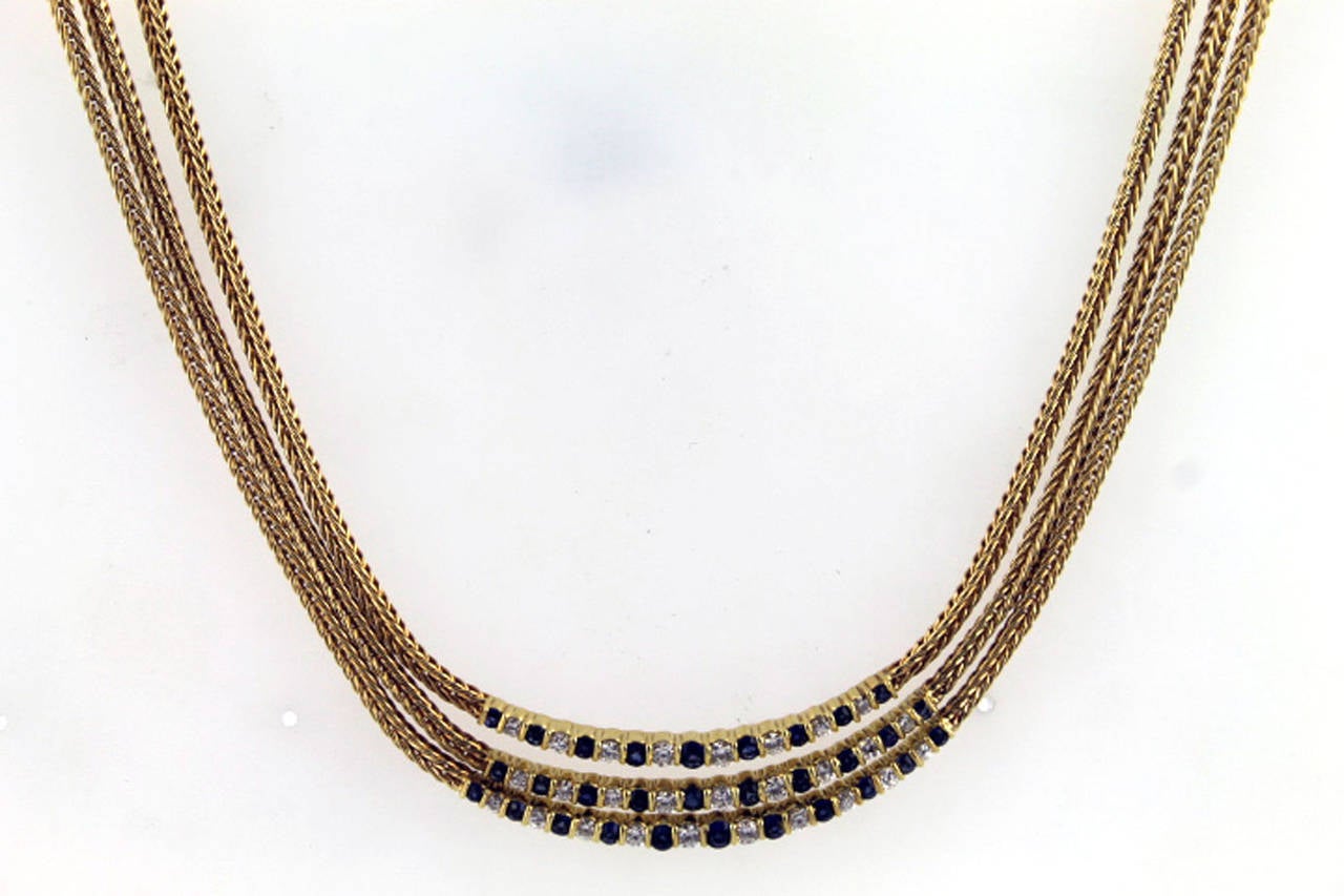 This Vintage 1970's Tiffany Diamond and Sapphire multi-strand necklace is fashioned in 18 karat yellow gold. There are a total of 27 round brilliant cut diamonds weighing approximately 1.00 carat total weight. The three separate diamond and sapphire