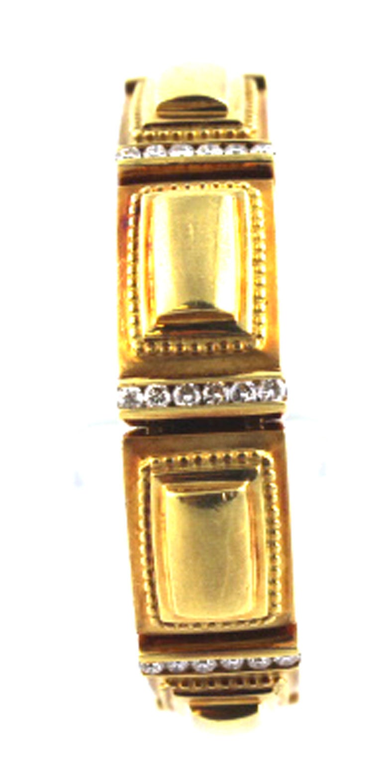 This gorgeous 18 karat yellow gold and diamond bracelet was made by designer Seiden Gang. There are 7 diamond stations with a total of 2 1/2 carats total weight. The Etruscan Design of the past gives great character to the bracelet. The clasp is