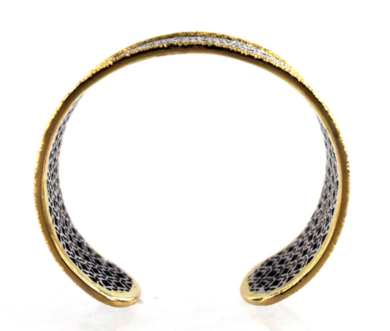 This stunning cuff bracelet has diamonds set in 18 karat white gold, and an 18 karat yellow gold trim.  There are approximately 5.46 carats of round brilliant cut diamonds. The yellow gold textured trim is simple, but creates dimension and character