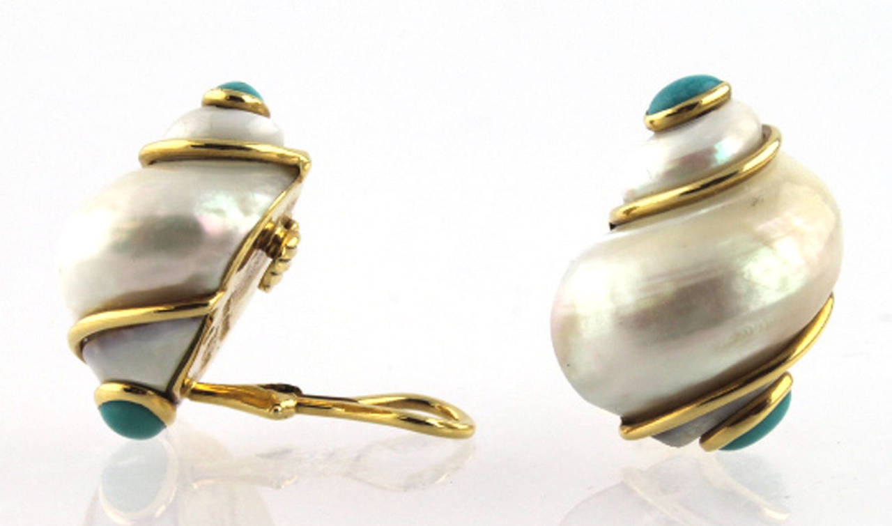 18 karat yellow gold Seamon Schepps pearl, and turquoise shell earrings from the Turbo Shell Collection. The cabochon turquoise stones are set at the top and bottom of the earrings. The earrings are clips with omega backs, signed and hallmarked