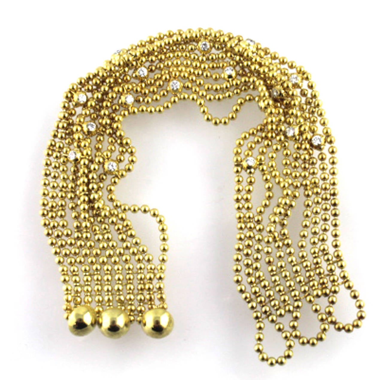 Fabulous Cartier bracelet with 17 round brilliant cut diamonds set in 18 karat gold. There are 10 strands that together measure about 1 inch wide, and the length is 7 inches.  The clasp is an easy to use button style closure. 
Signed Cartier,
