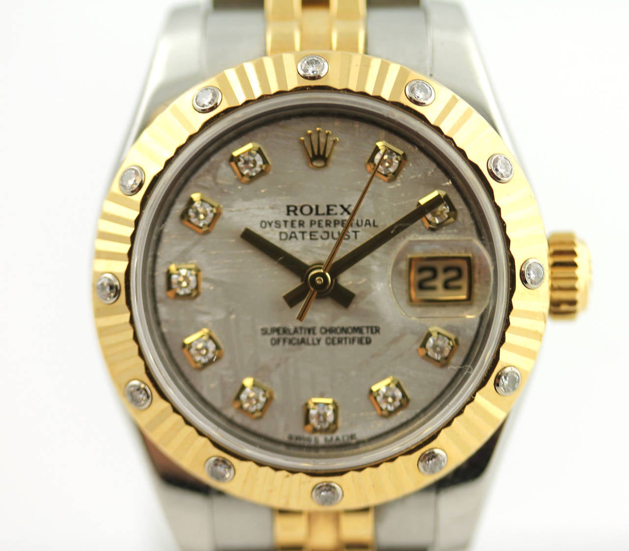 Lady's Rolex Oyster Perpetual Datejust in stainless steel and 18 karat yellow gold features a fluted bezel set with 12 diamonds, a meteorite diamond dial, and jubilee style bracelet. All diamonds are original factory set diamonds. Box included.