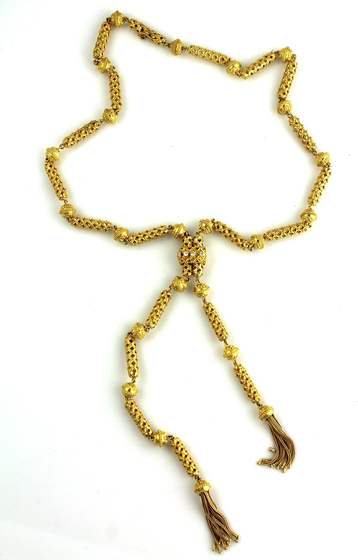 Versatile and fashionable 22 karat yellow gold Lariat necklace can be worn many different ways. The clasp is set with three diamonds, and is removable and adjustable. The textured links, tassels, and clasp gives the necklace style and flexibility. 