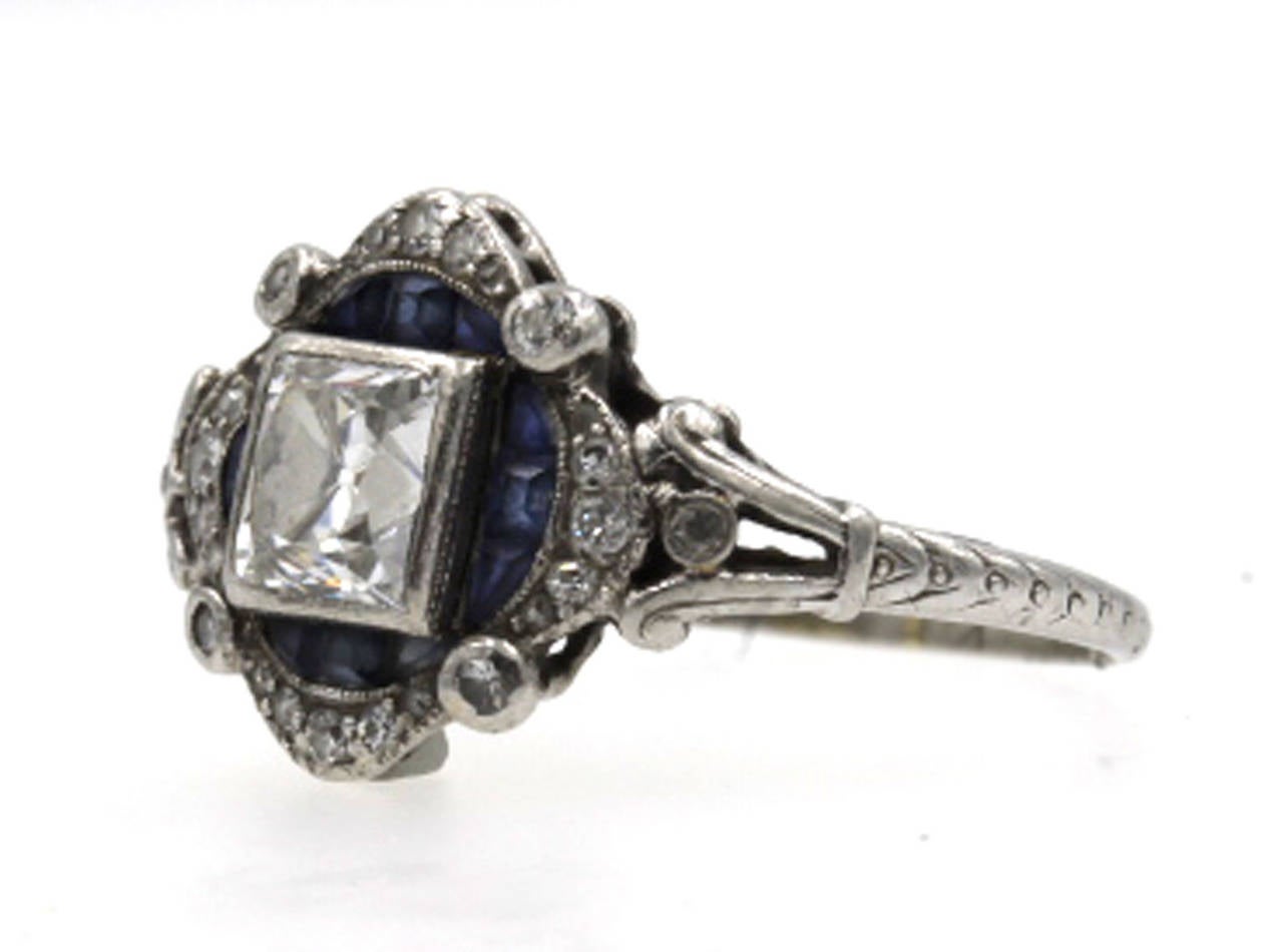 Original Art Deco Platinum Diamond and Sapphire engagement ring by Tiffany and Company. The French Cut center diamond is approximately 3/4 carats, surrounded by original sapphires and accent diamonds. The diamond is H color and SI1 clarity.  The
