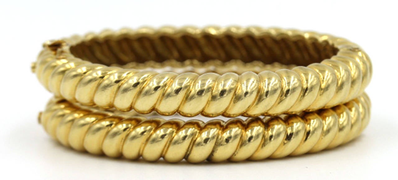 Timeless 18 karat yellow gold twisted bangle bracelets by renowned designer David Webb. The bracelets are priced as a set, but can be sold separately. The bracelets measure 6 inches in length and are 8mm around. There is a safety clasp on each
