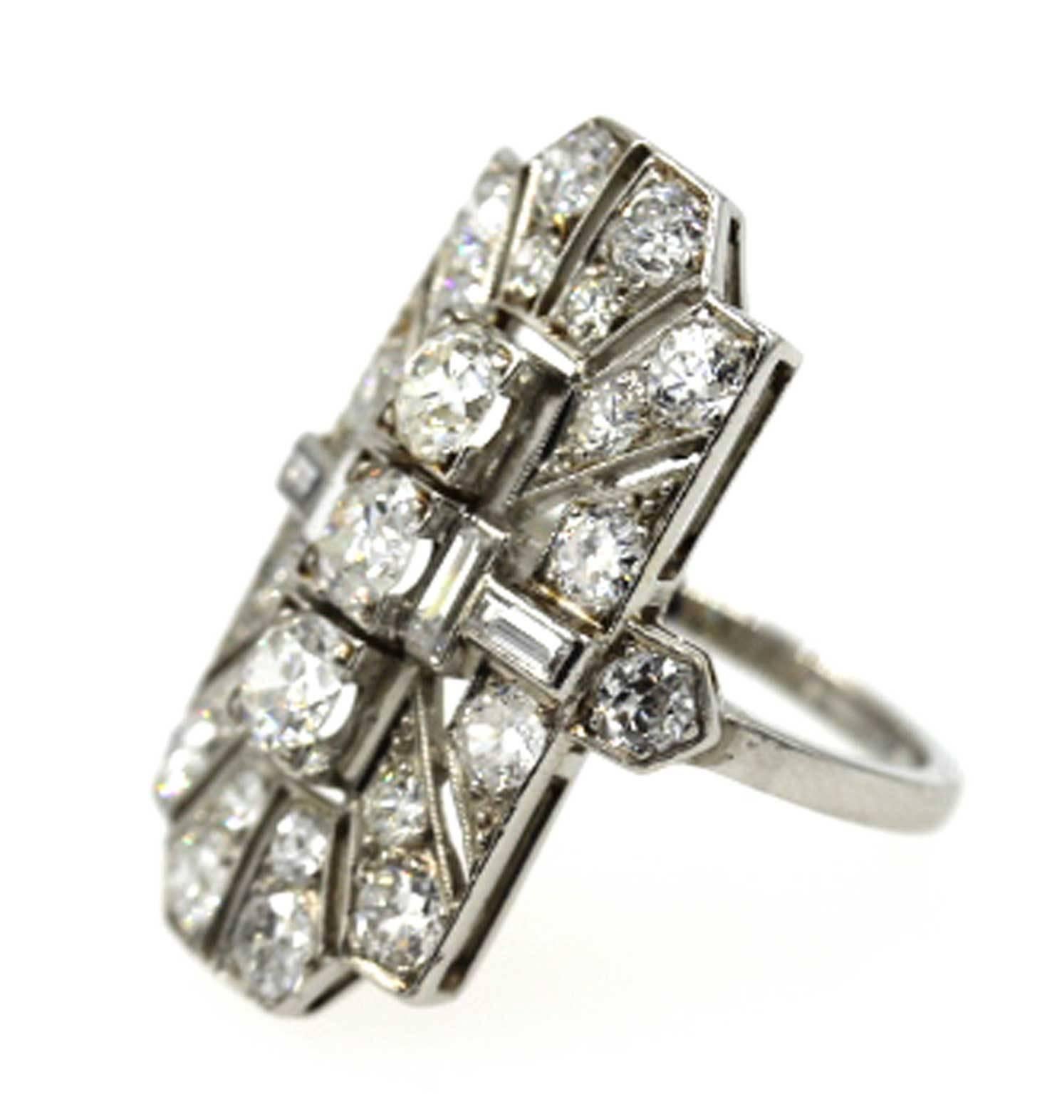 Platinum and diamond dinner ring from the Art Deco period. The geometrical shaped ring features Old European Cut and baguette cut diamonds equaling approximately 2 1/2 carat total weight. The ring is currently sized to a 4 1/4, but can be sized up