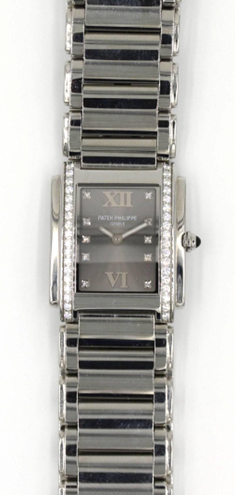  Patek Philippe Twenty-4 4910/10A Ladies Steel & Diamond Watch.  The tank shape watch, 25 x 30 mm, is set with 36 round brilliant cut diamonds in the bezel, quartz movement, and a black dial.  Pre-owned and in excellent condition.  Model 4910/10A. 