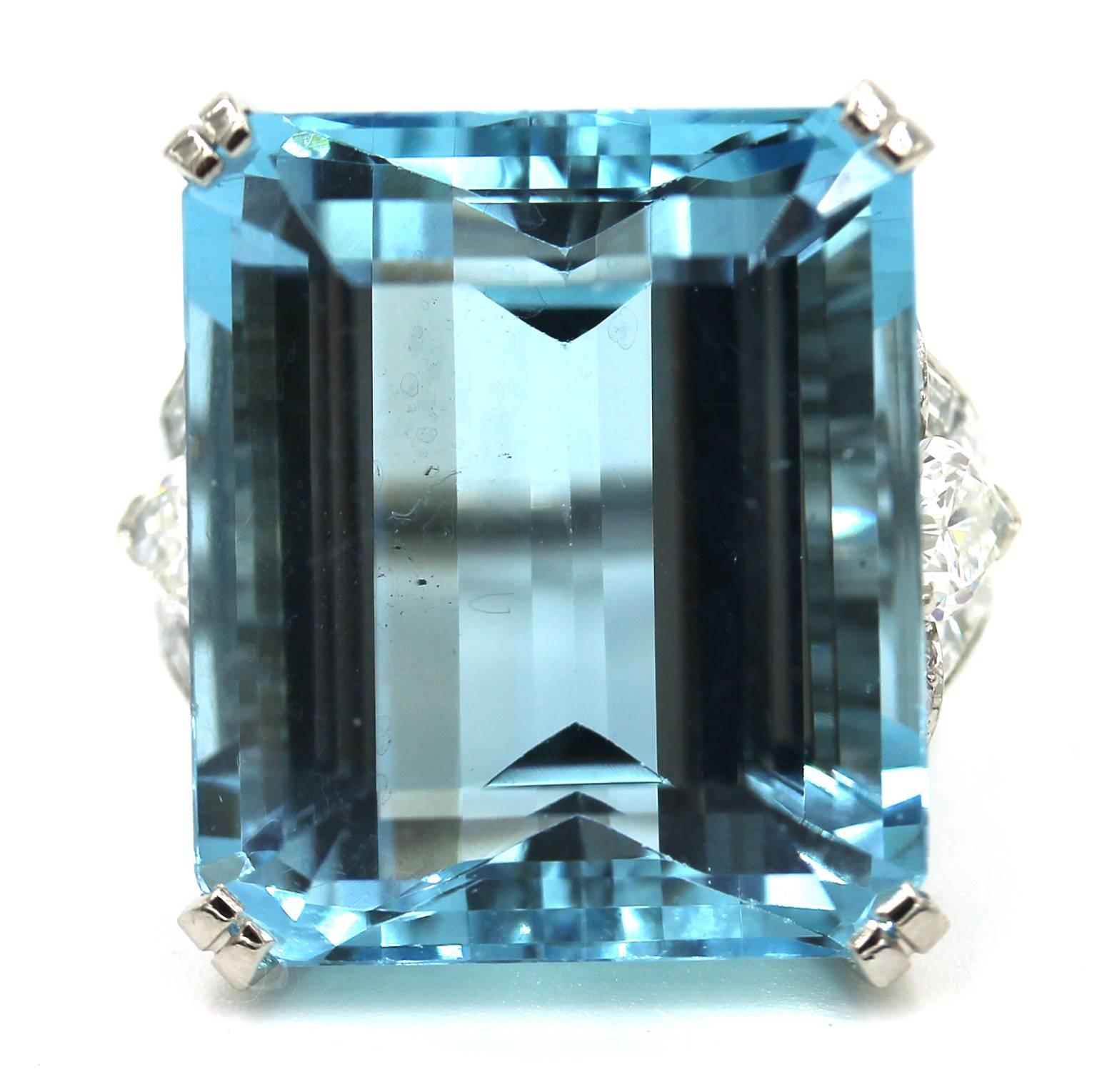 This fabulous estate ring features an emerald cut aquamarine and diamonds in a platinum setting. The aquamarine measures 21mm x 18mm by 12.3 mm deep, and weighs approximately 32.50 carats. 
There are 2 pear shaped brilliant cut diamonds, 16 single