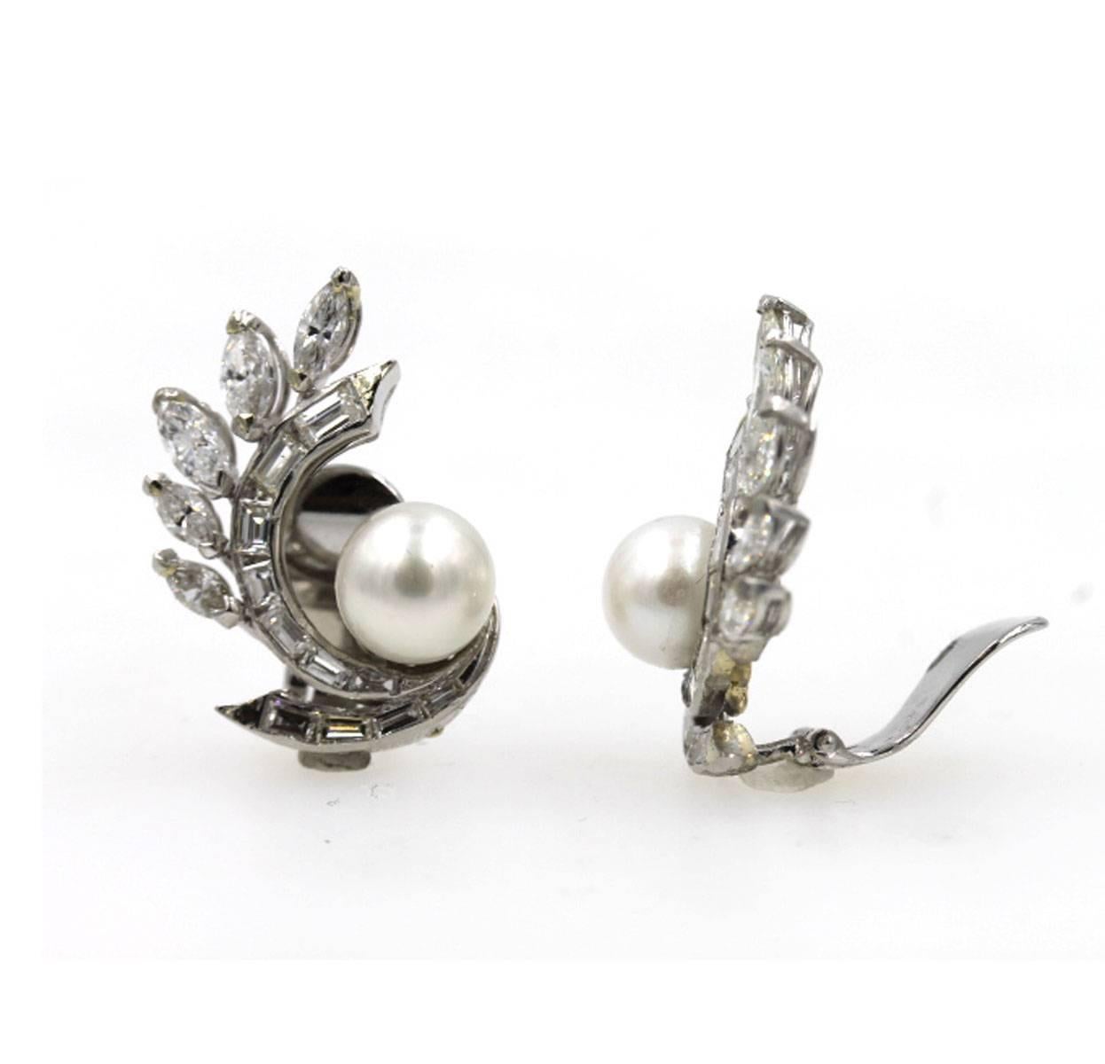 These 1940's diamond and pearl platinum earrings by Van Cleef & Arpels feature approximately 3 1/2 carat total weight of diamonds (10 marquis, and 22 baguette cut diamonds). The pearls are 8.5mm, and the earrings measure 1 inch in length, and 3/4