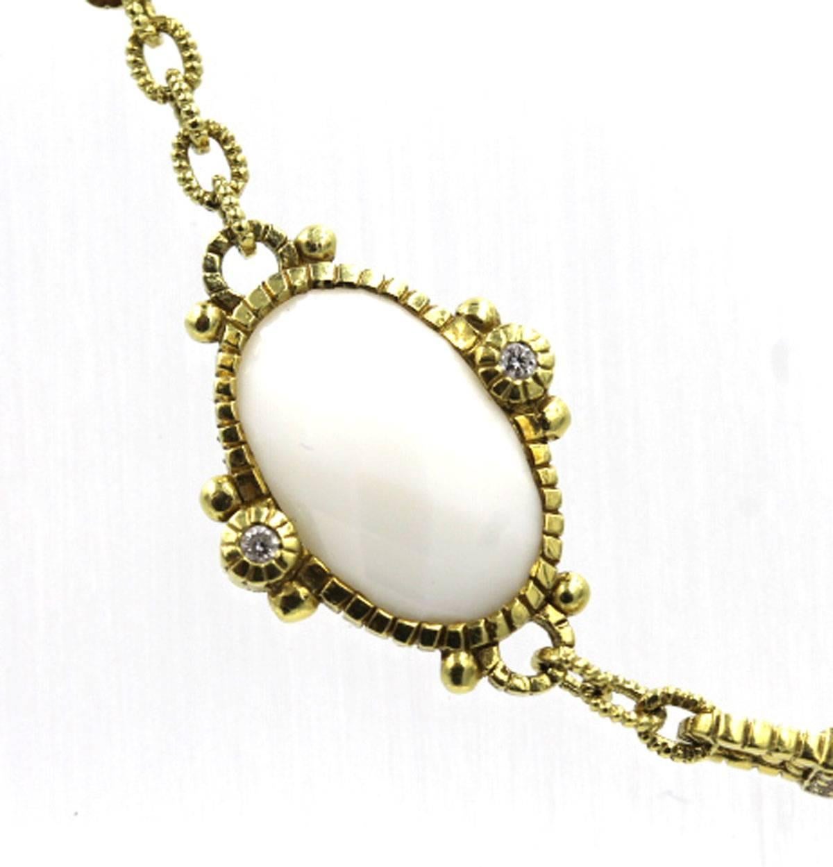 Designer necklace by Judith Ripka features 1/3 carat total weight of diamonds, and white agate set in 18 karat yellow gold. The 17 inch necklace is signed Judith Ripka, and retails for approximately $5,800.
