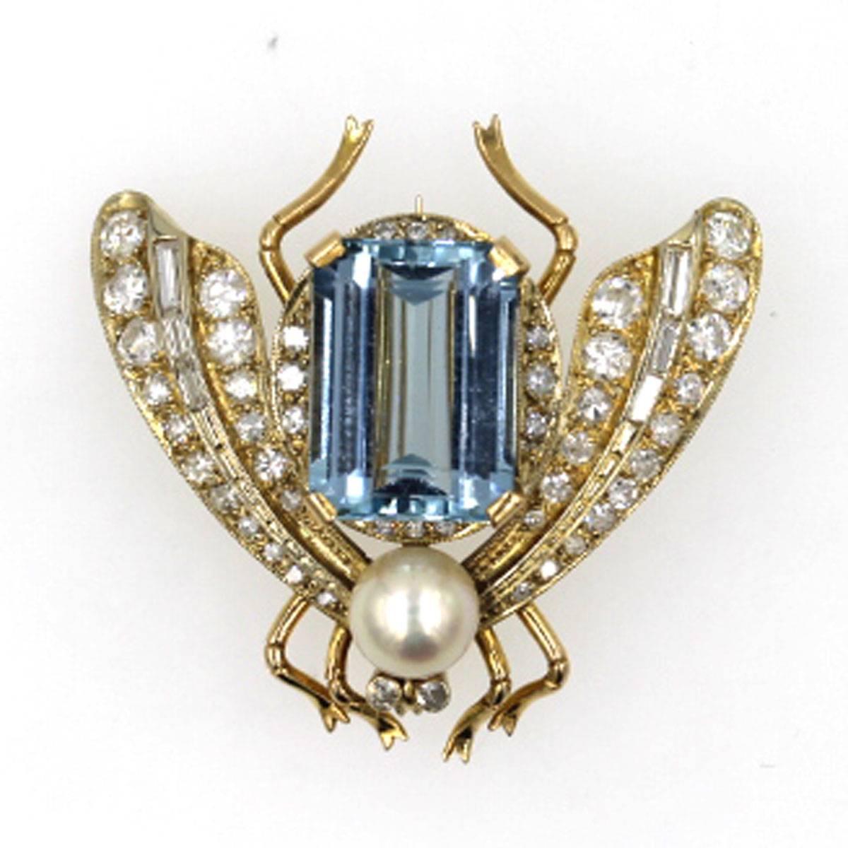 This original 1950's pin features transitional and single cut diamonds that equal 1 1/2 carat total weight. The center body is a high quality aquamarine that is approximately 7 carats. The brooch is set in 18 karat yellow gold and measures 1.5