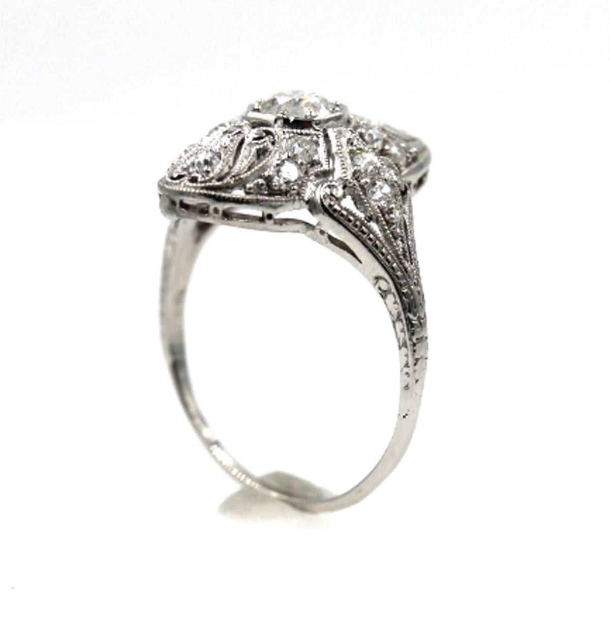 This gorgeous Art Deco ring features a .47 carat Old European Cut diamond with F color and VS quality. GIA certificate number 1156584328. Around the center are 1/2 carat total weight of side diamonds set in platinum. The ring measures 20mm from top