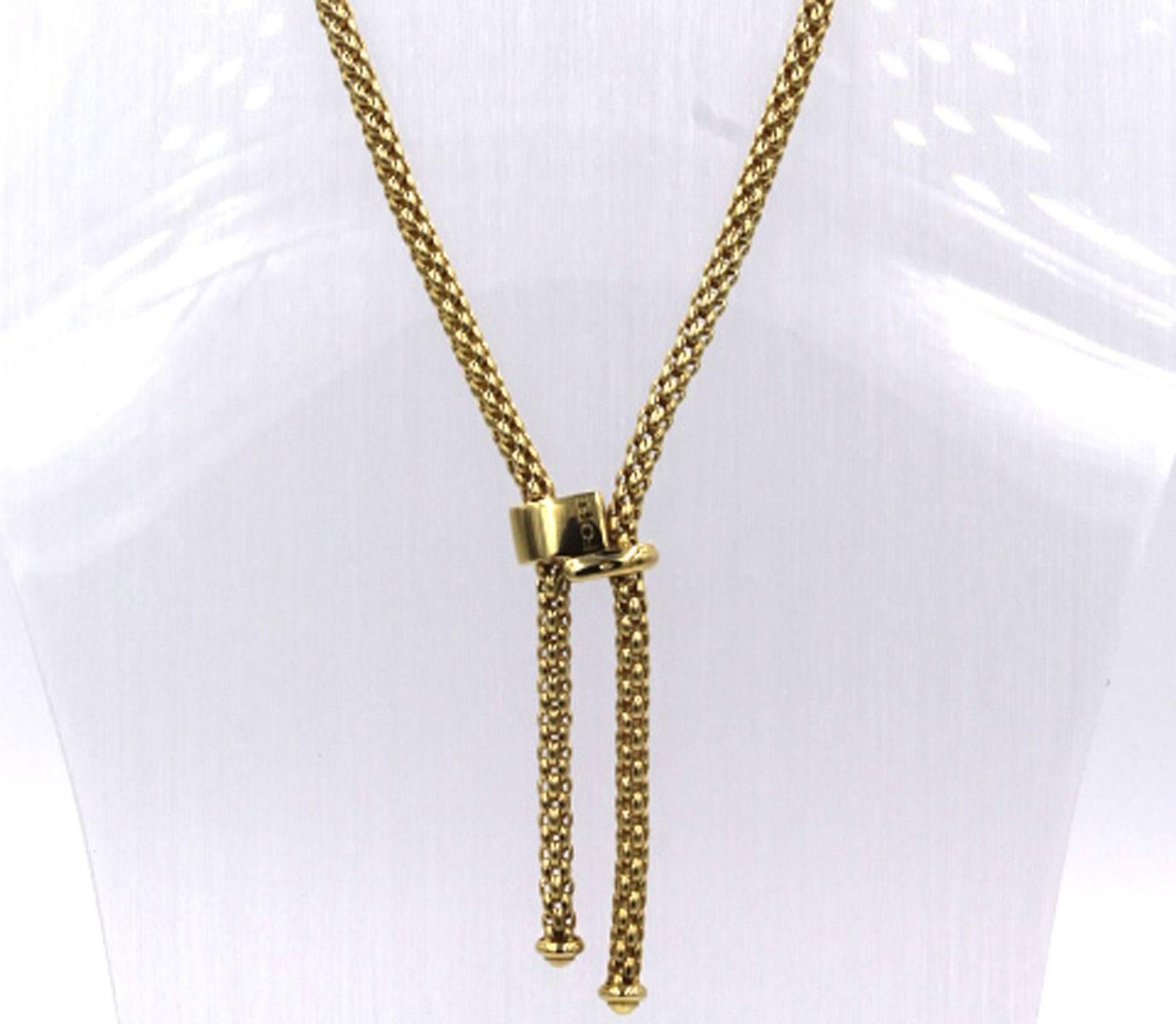 This versatile lariat style necklace by Italian designer Fope is fashioned in 18 karat yellow gold. The necklace measures 16 inches with a 2 inch drop. The clasp is stationary, and the ends are signed Fope. 