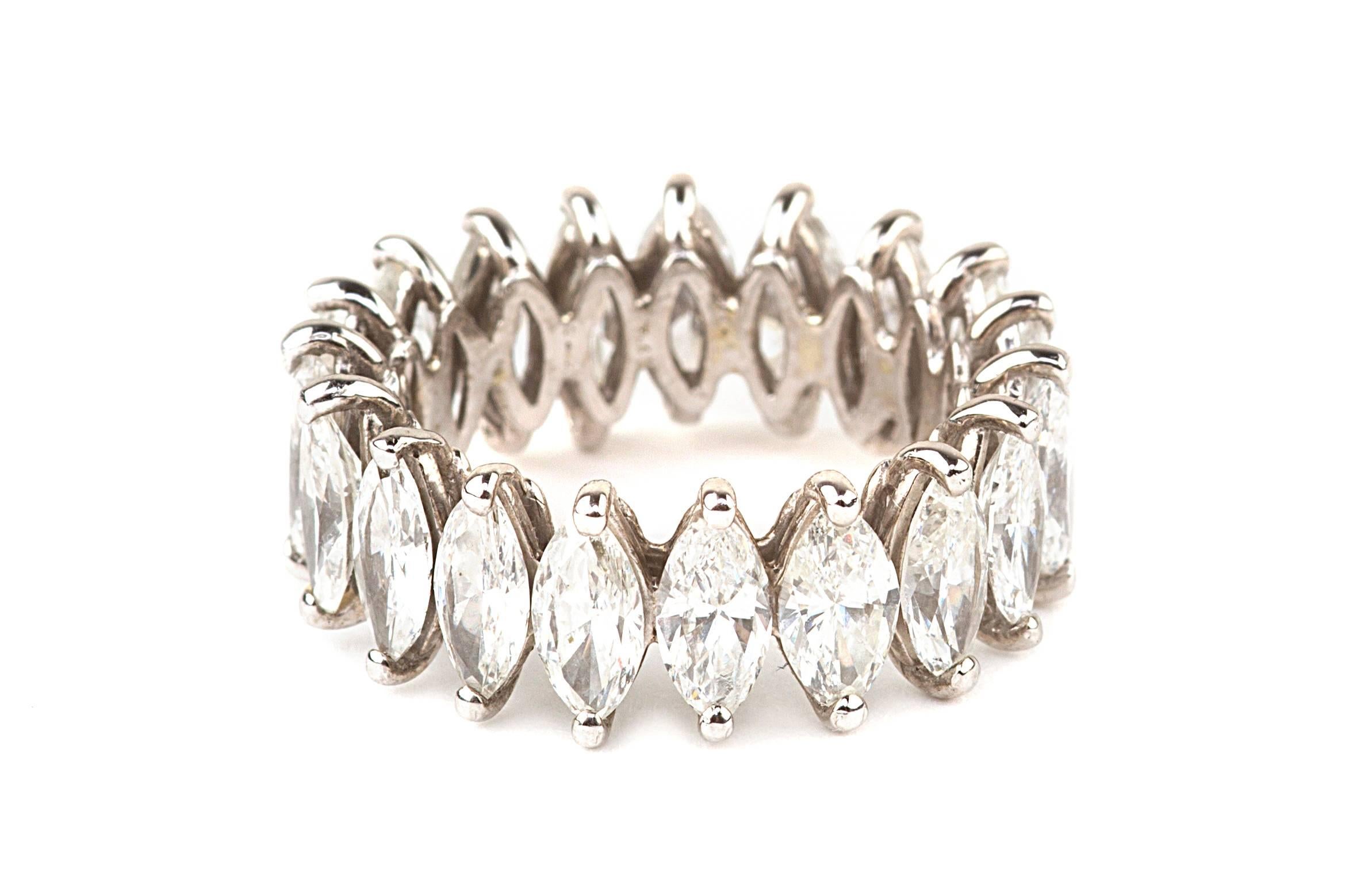 This estate eternity band features 19 marquise shaped diamonds that equal approximately 7.0 carat total weight. The diamonds are graded H/I VS2-SI1, and the ring is size 5 1/4. The band is 14 karat white gold. 