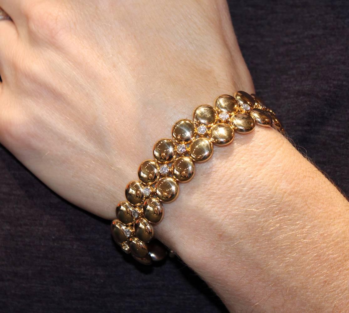 Fabulous diamond and gold reversible bracelet by Cartier features an 18 karat yellow gold side with 20 round brilliant cut diamonds weighing approximately 2.00 carat total weight. The reverse side is fashioned in 18 karat white gold without diamonds