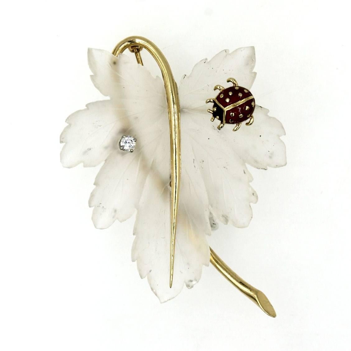 This beautifully crafted crystal and yellow gold pin by Tiffany & Company features a carved crystal leaf, an enamel lady bug, and  a single full cut diamond. The pin measures 6cm in length and 4cm in width. 