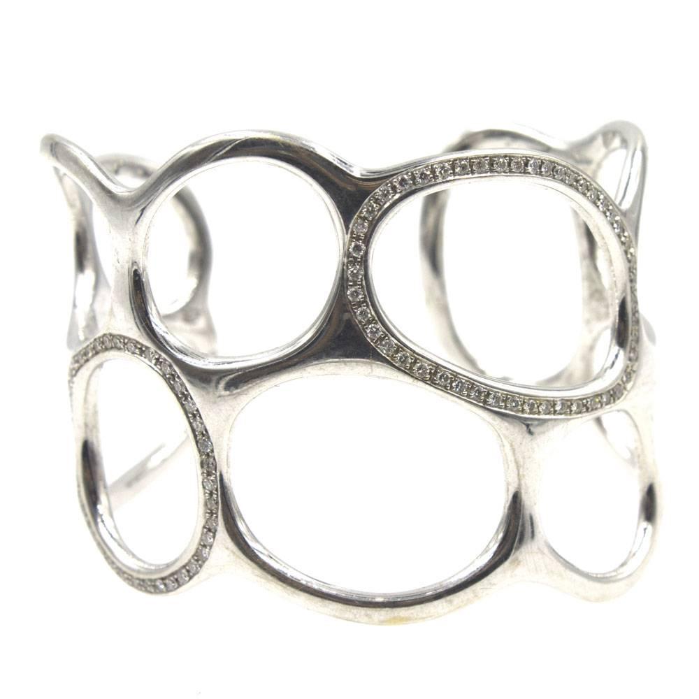 Beautiful contemporary sculpted wide cuff in 18 karat white gold by designer Gavello. The bracelet features an open design and sparkling round brilliant cut diamonds. There are approximately 1.00 carat total weight of diamonds. The cuff measures