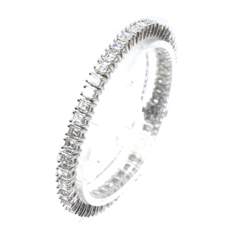 Luxurious 10.5 carat diamond tennis bracelet. Each brilliant square emerald cut diamond weighs approximately .25 carats and is graded G-H color and VS clarity. Crafted in platinum, this timeless bracelet measures 6.5 inches.