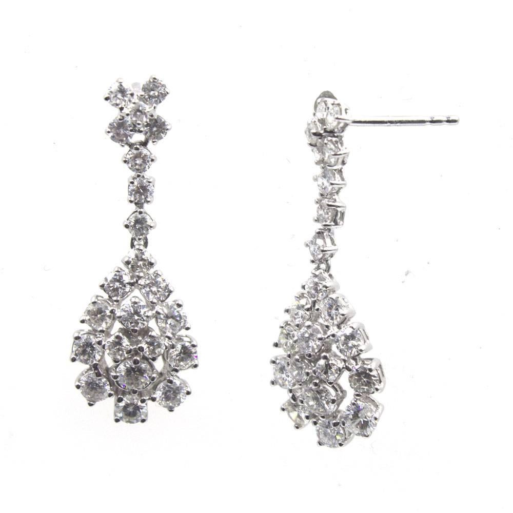 These fabulous diamond drop earrings, circa 1970's, feature approximately 3.00 carats of sparkling diamonds that dangle 1.25 inches in length. The round brilliant cut diamonds are graded G-H color and SI1 clarity. Great for a night out on the town!