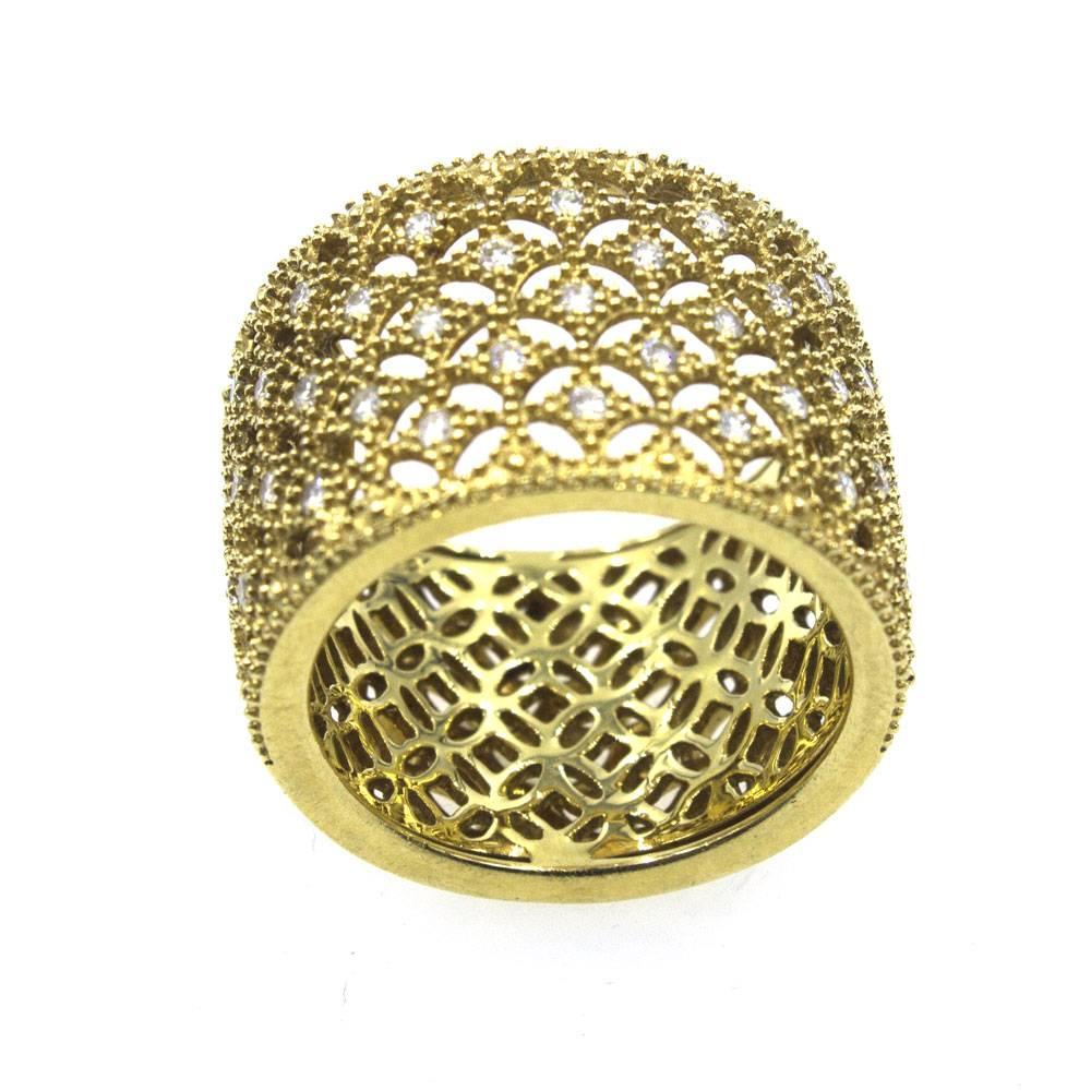 This stylish 18 karat yellow gold band features round brilliant cut white diamonds set in a open lattice design. There are approximately .50 carat total weight of diamonds. The band measures 15mm in width and is size 7. 