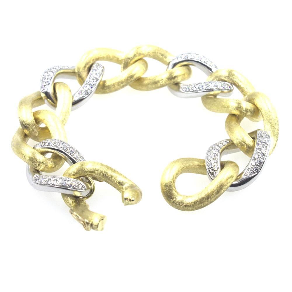 This gorgeous Italian diamond link bracelet is crafted in two tone 18 karat gold. The luxurious satin finish yellow gold links are connected by diamonds links fashioned in white gold. There are approximately 2.00 carat total weight of diamonds in