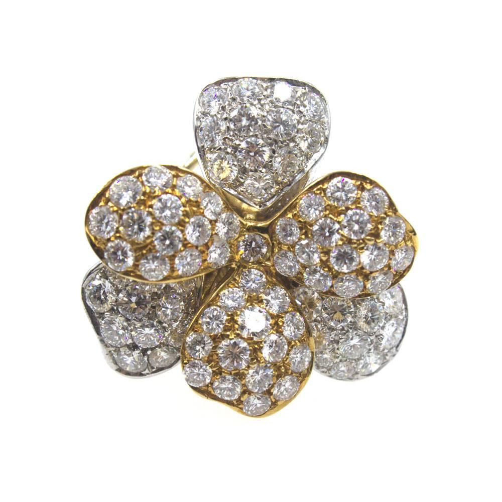 These magnificant floral diamond earrings are fashioned in 18 karat yellow and white gold.   The floral leaves alternate white and yellow gold. The earrings feature 8 carats of high quality round brilliant cut diamonds graded F color and VS clarity.