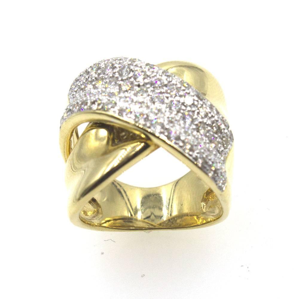 This fabulous crossover ring features round brilliant cut diamonds set in 18 karat yellow gold. The wide band ring features 65 sparkling diamonds that equal approximately 1.47 carat total weight. The band measures .75 inches in width, and is