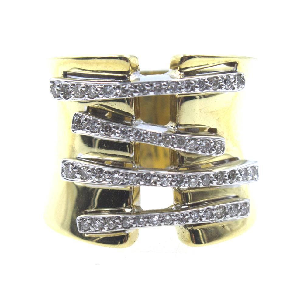 This stunning ring features a corset of round briliant cut diamonds set in 18 karat white gold. The rest of the wide band is crafted in 18 karat yellow gold and measures from 12-20mm in width. The open diamond design features approximately .50 carat