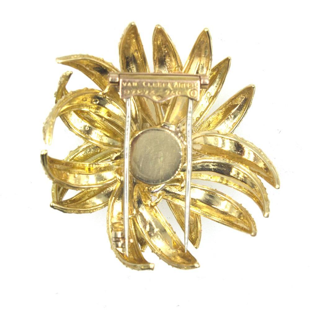 Beautifully crafted Mid-20th Century French floral brooch by Van Cleef & Arpels. The hand crafted floral design features an approximately .95 carat round brilliant cut diamond surrounded by 8 more round brilliant cut diamonds that equal