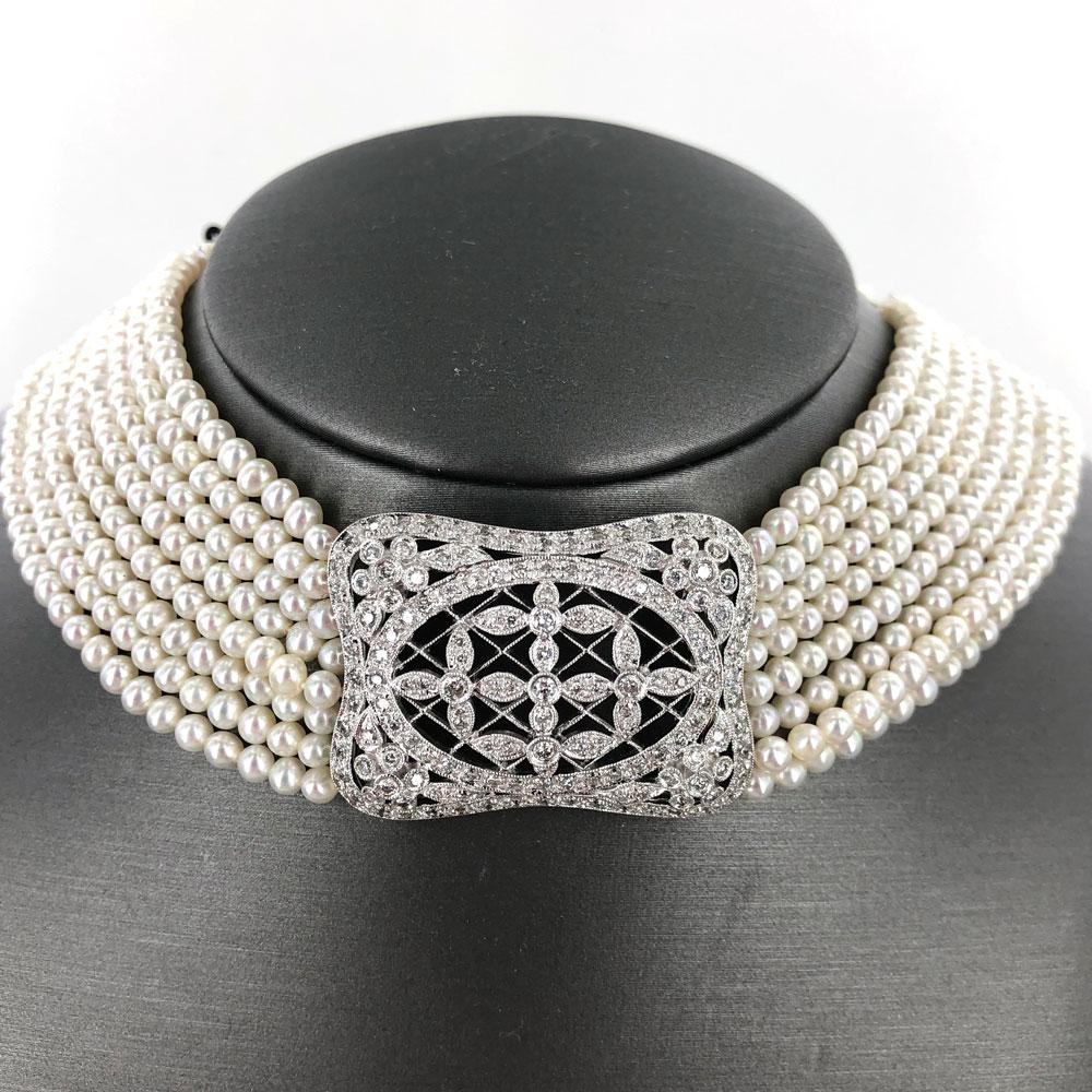 Elegant diamond pearl choker necklace. A beautiful diamond centerpiece features over 2.00 carats of round brilliant cut diamonds. Diamonds (approximately .40 ctw) are also set in white gold bars along the necklace and on the clasp.  The multi-strand