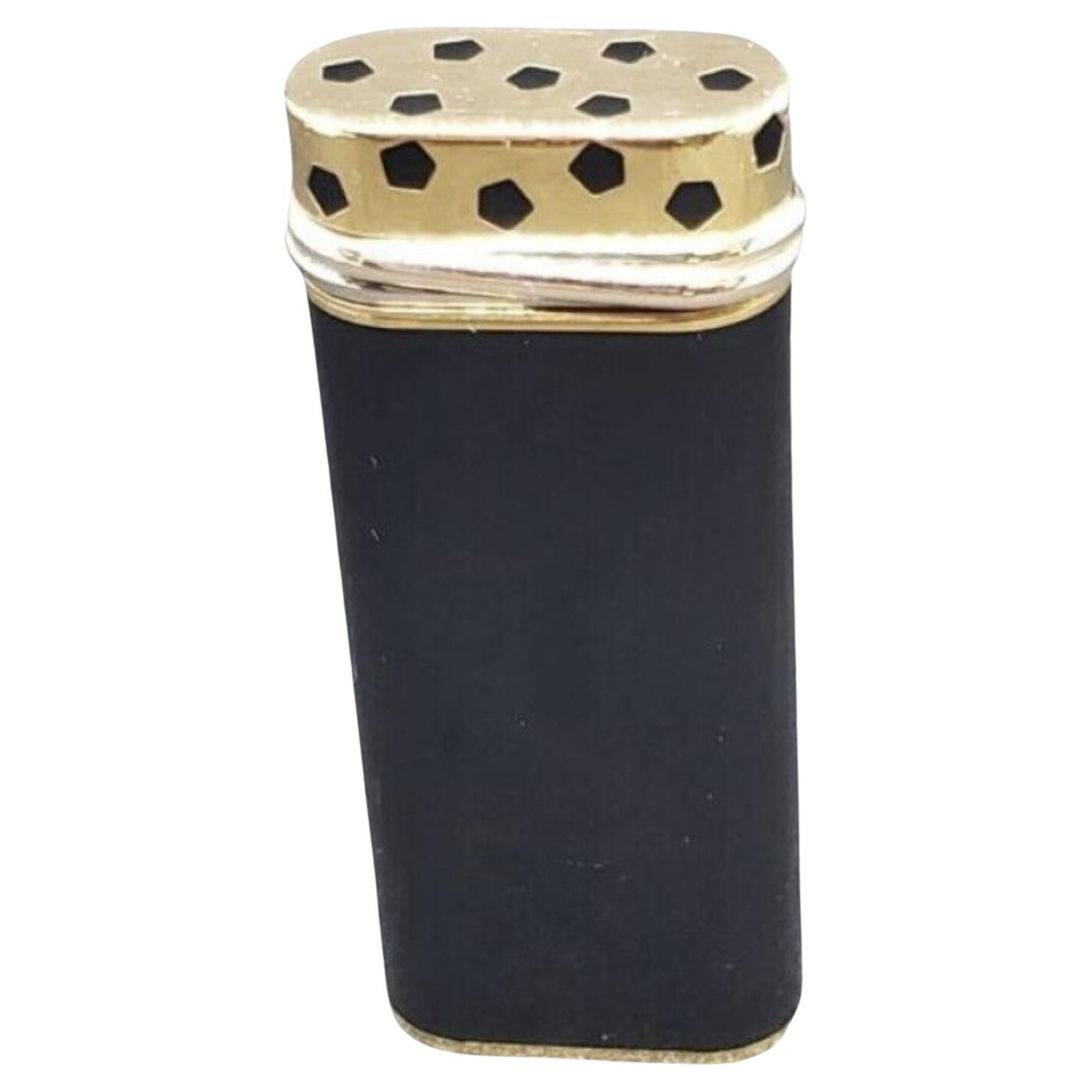 Cartier Rare TRINITY 
Black Lacquer & 18 K Gold plated lighter 
Circa 2000
In fantastic condition 
The Lighter comes with a original Cartier case 
Original Cartier certificate, booklet & papers 
Original Cartier booklet cover 
The lighter, sparks,