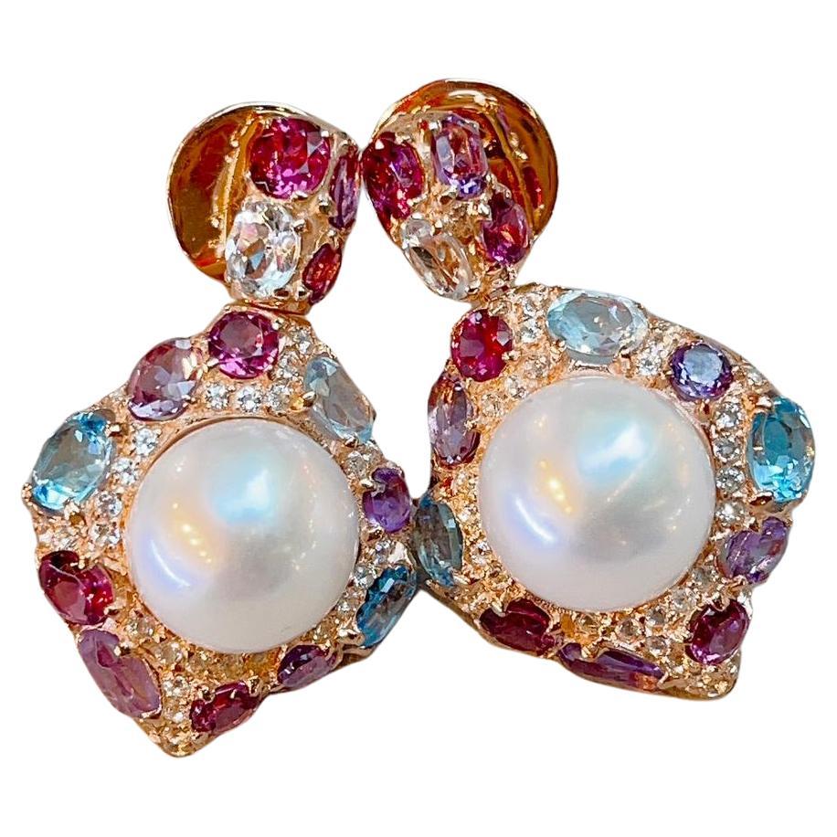 Bochic “Capri” Multi Natural Gem Earrings 
Natural Amethyst,  Colors - Purple - 6 Carats 
Natural White and Blue Topaz - 7 Carats 
Natural Rodorite, Colors - deep win Red - 5 Carats 
South sea pearls, Colors - White with slight silver and pink tones