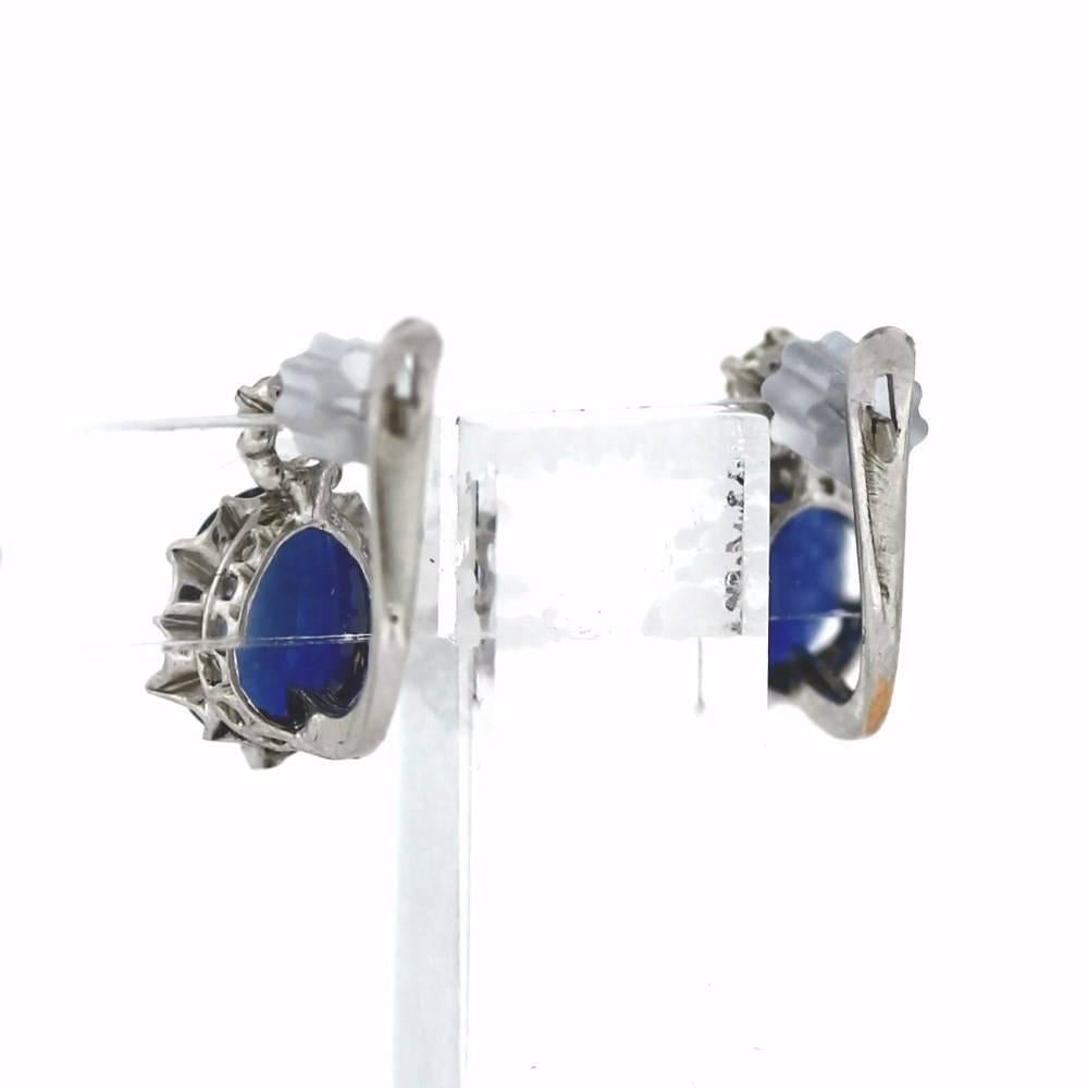 Two Oval Sapphires are about 2.50tcw with 2 old european cut diamonds about .20tcw.  The mounting is a newer cast 14K White gold Leverback with some detail engraving on the back.