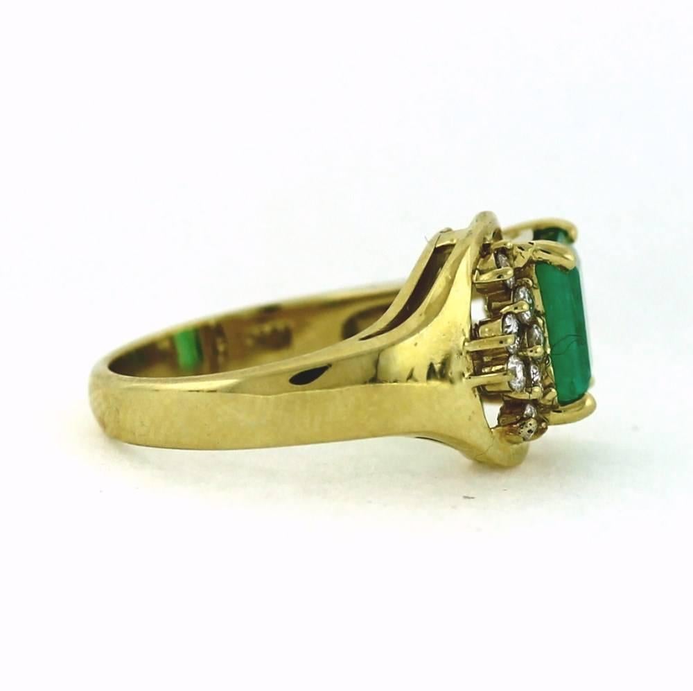 1985 was a great year!  This ring has a huge look at a little price!

One emerald cut green emerald surrounded by diamonds in a buckle style design.  Emerald is about 2.00tcw and diamonds are about .50tcw.  Size 7.5, sizable.