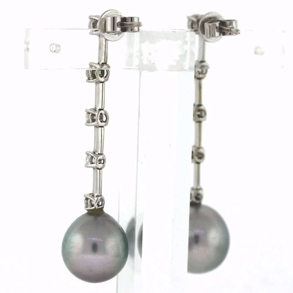 Beautiful Silver Tahitian pearls hanging from 5 diamonds on each ear!  Signed Cartier.  10 round brilliant diamonds weigh about 1.20tcw.  Retail is $24,250