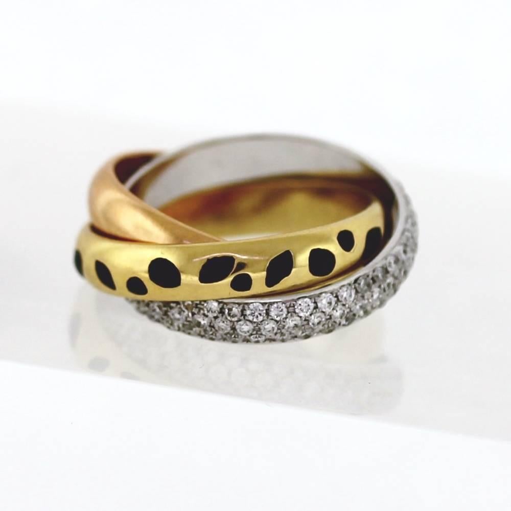 Beautiful Roll Ring by Cartier... The ring features 3 bands.  One band is 18k rose gold, one band features 18k yellow gold with magnificently done black enamel, and one band contains pave style round white diamonds of collection quality color and