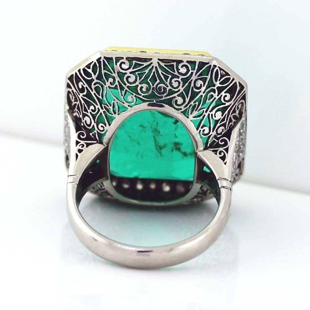 This Platinum and 18K Yellow Gold ring holds a Gorgeous Colombian Emerald weighing 26.63 carats with a perfect Muzo Green Color, lightly included accompanied by an AGL certificate.  I love this ring!  The gem stone is so amazing because it faces