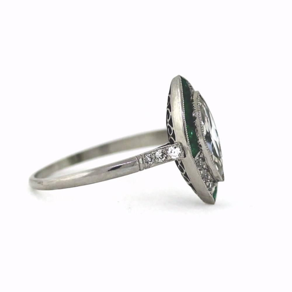Beautiful Original Art Deco Ring featuring a .67ct Marquise cut diamond in the center H color, Si1 clarity.  12 beautiful green emeralds that weigh approximately .12ctw.  Approximately .15ctw of european cut diamonds.  

This ring is a size 7.  It