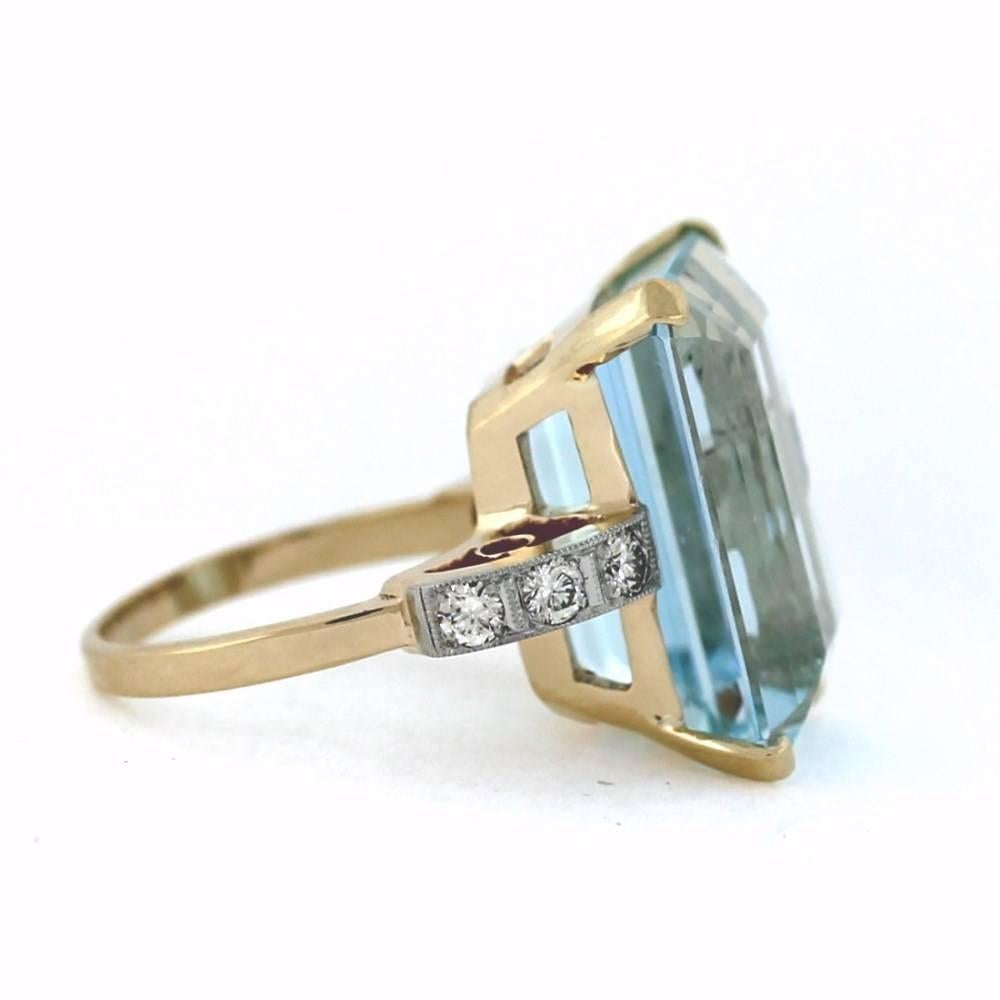 A beautiful antique aquamarine ring...  Deep Blue colored Aquamarine gemstone featured in the center of this ring.  The aquamarine weighs a total of 22.33 carats.  The ring is made in 14k yellow gold and contains 6 white round diamonds weighing